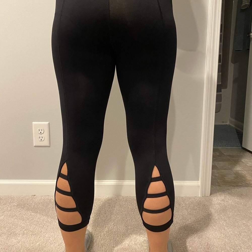 Black cropped tights with calf cutout.